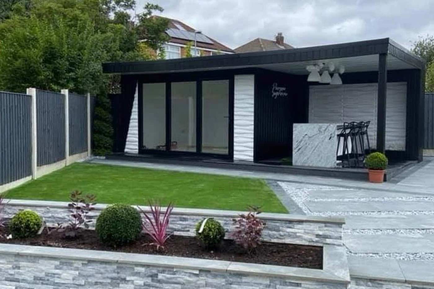 A garden room with outdoor bar and eaten area, supplied and built by Prima Construction, professional builders in Stockport.