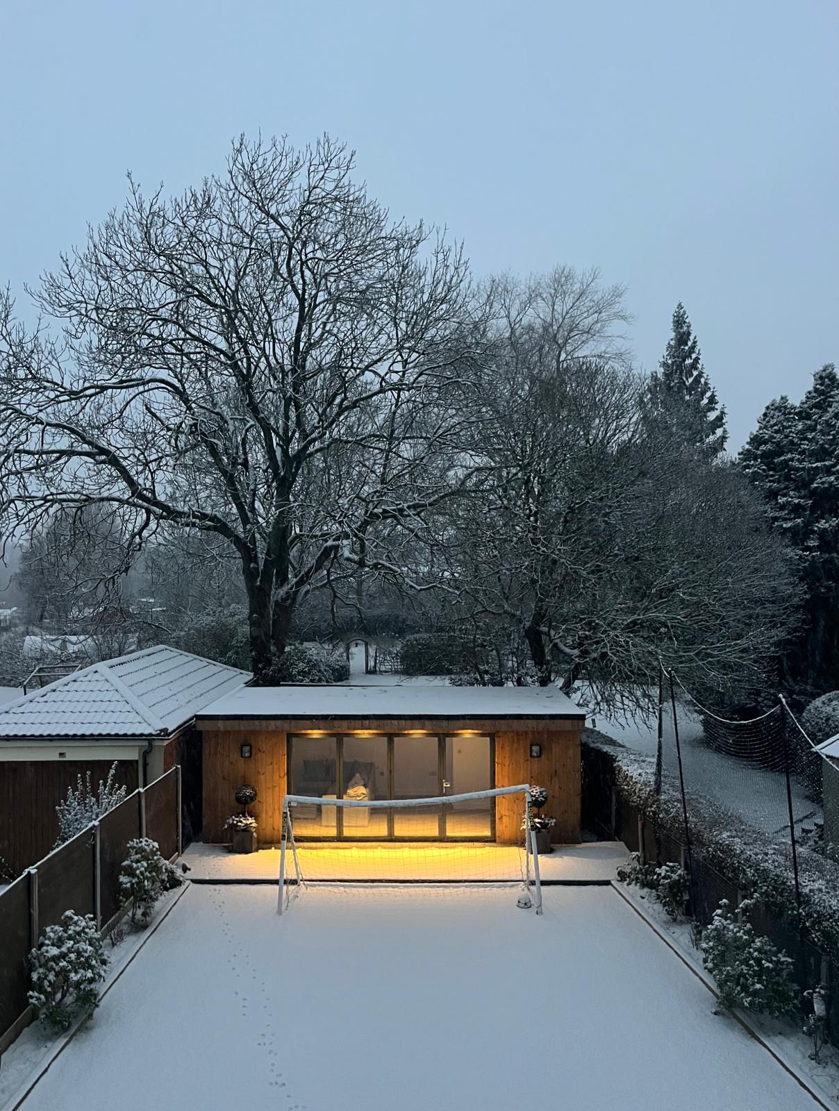 Outdoor office garden room in Stockport by Prima Construction shown here in the snow