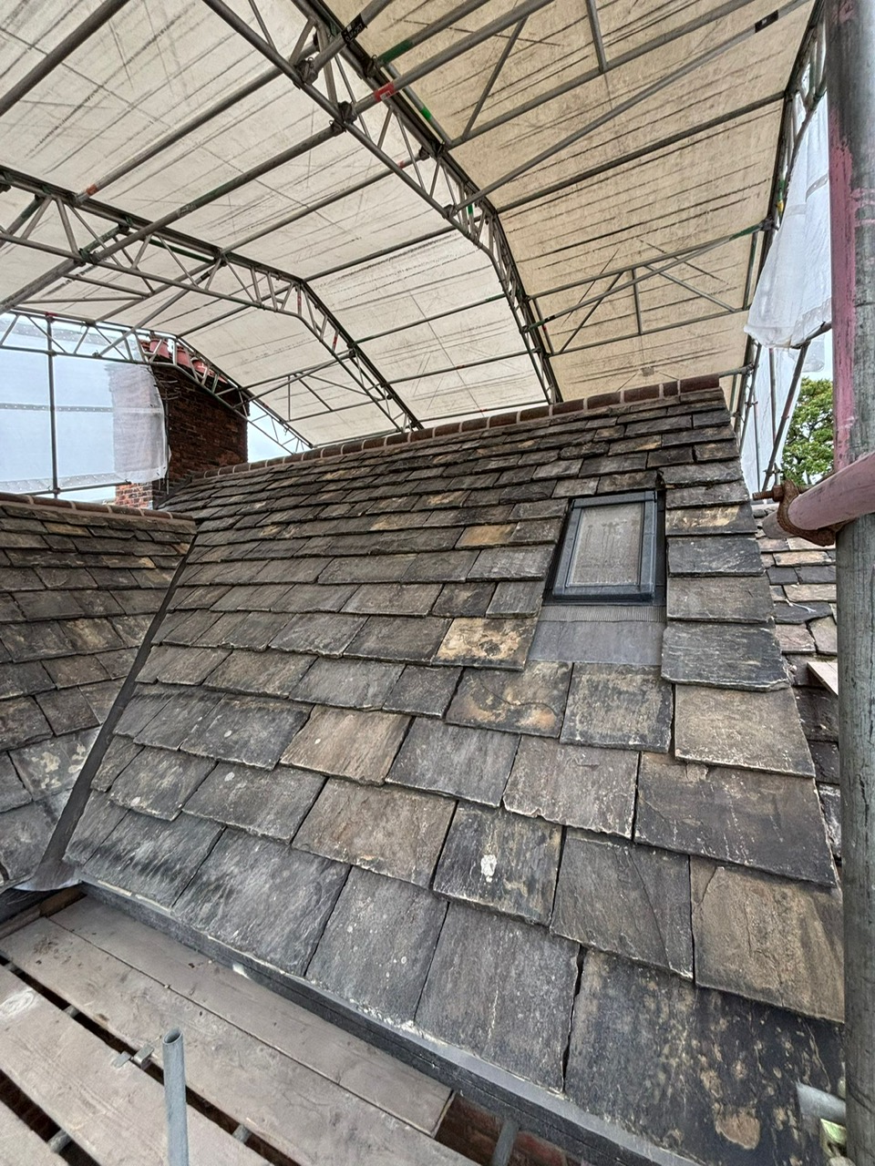 Velux window being installed on a slate roof in Stockport